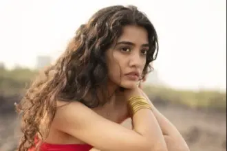 Aarushi Bajaj in a vibrant pink dress with a thigh-high slit