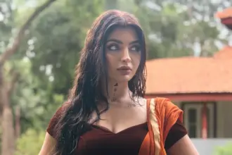 Akanksha Puri in an orange and gold saree