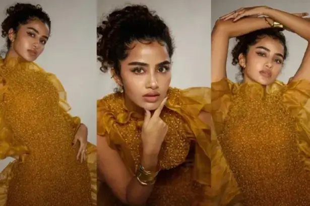 Anupama Parameswaran posing in a vibrant yellow dress during a photoshoot