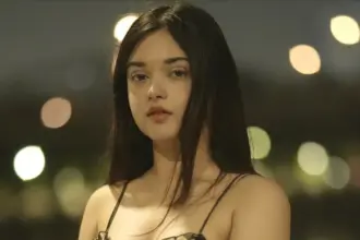 Mahek Syed in a black floral slip dress during a nighttime photoshoot