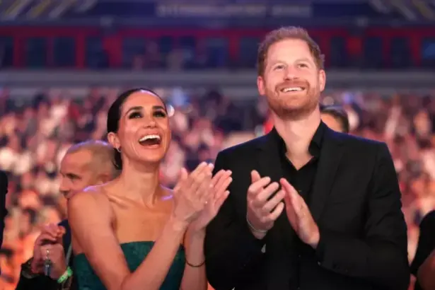 Meghan Markle and Prince Harry holding hands in the Cotswolds